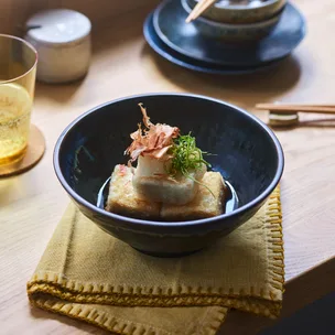 Agedashi tofu topped with bonito flakes and green onion