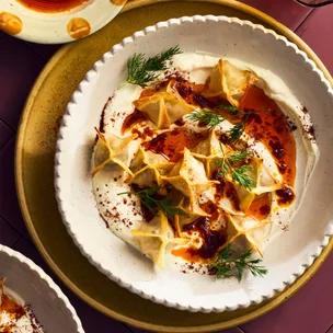 Baked manti on a bed of garlicky yoghurt, drizzled with sweet brown butter