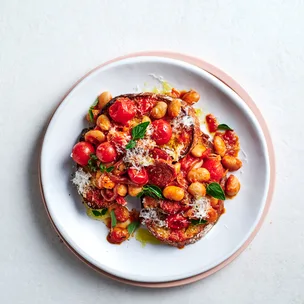 Beans and chorizo on toast on white plate.