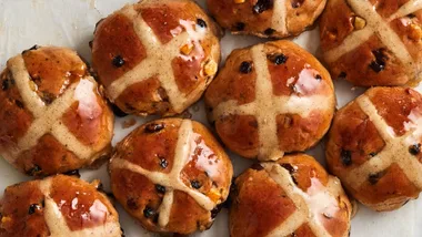A close-up shot of glossy hot cross buns, our most popular recipe for autumn