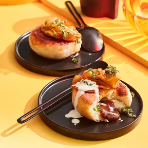 Korean fried doughnuts on black plate with yellow background.